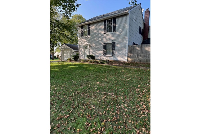 Back of property featuring a garage