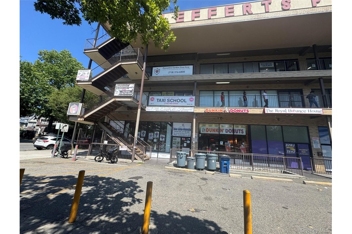 View of building exterior featuring uncovered parking