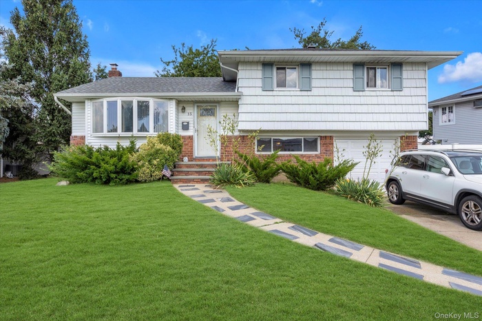 Tri-level Home Featuring Vinyl Siding & Brick Front, 1-Car Garage & Private Driveway