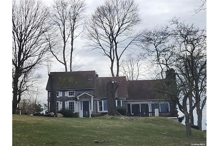 Rear view of property with a yard and a chimney
