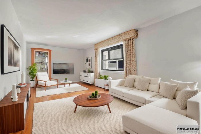 Living area featuring wood finished floors and cooling unit