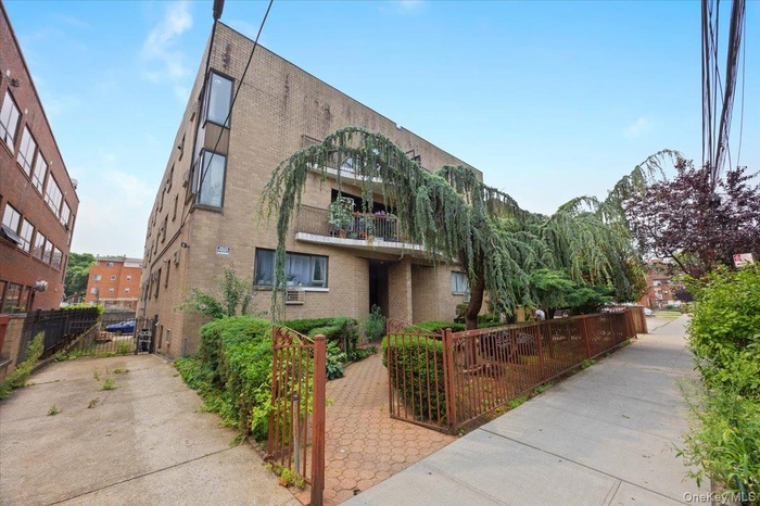 View of building exterior featuring a fenced front yard