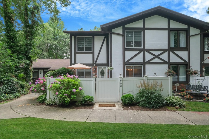 Back of property featuring a gate and a fenced front yard