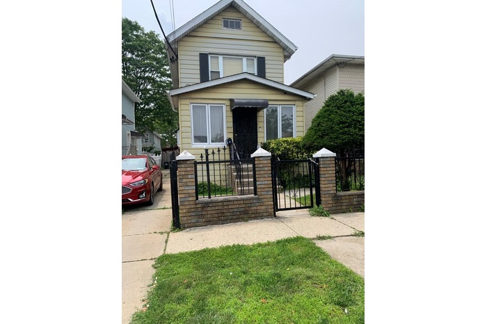Traditional style home with a gate and a fenced front yard