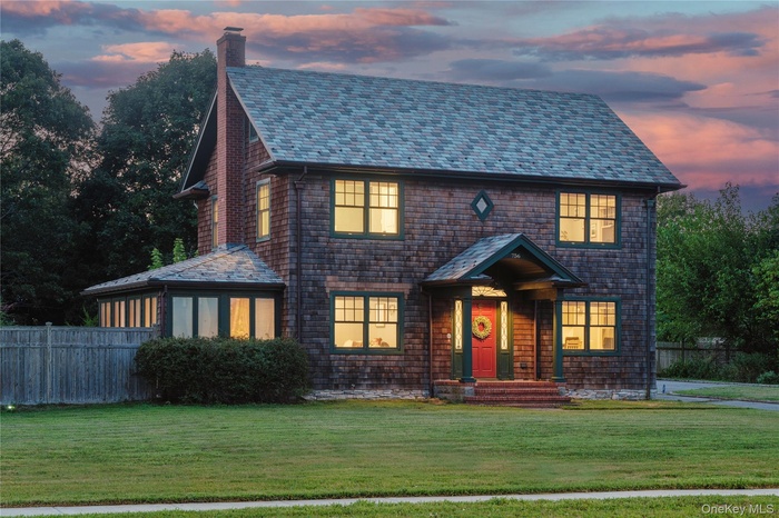 View of front of property with a high end roof and a chimney