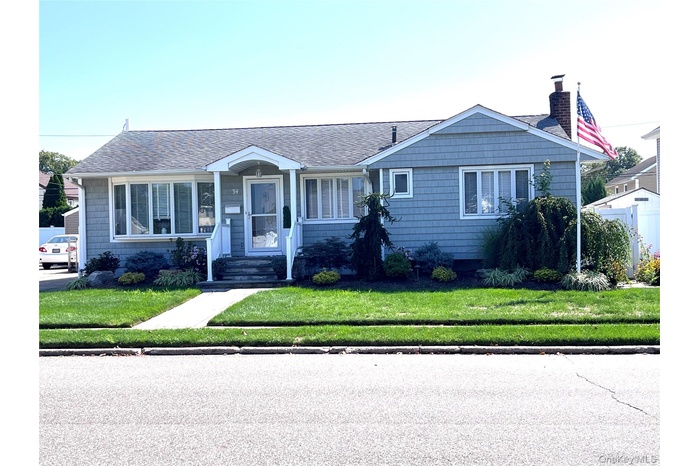 Bungalow featuring roof with shingles, a front yard, and a chimney