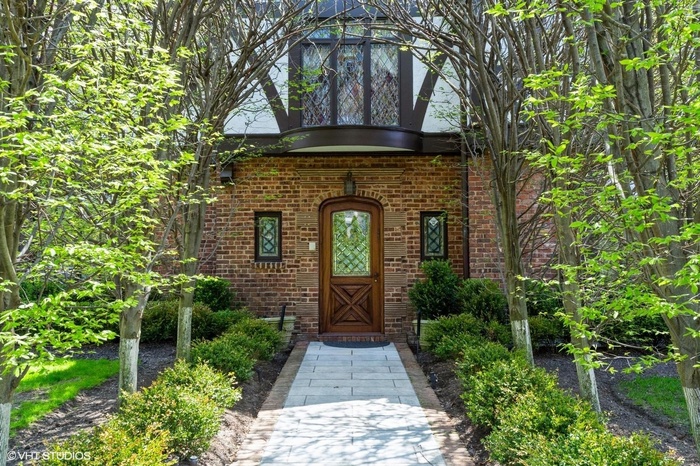 Entrance to property featuring brick siding