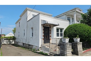 Larger legal two family dwelling with 2 car garage and sweet back yard just waiting for the right buyer.