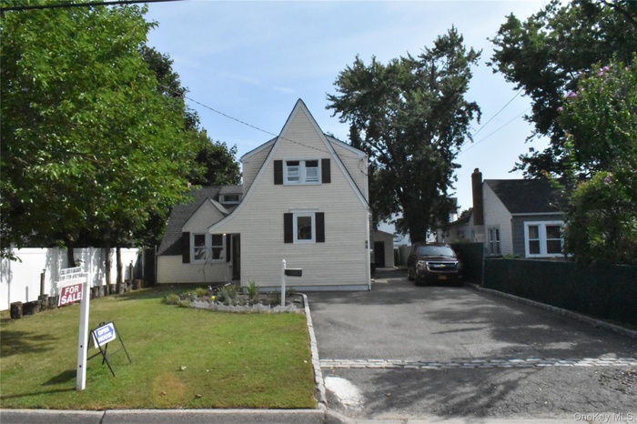 View of front facade with asphalt driveway