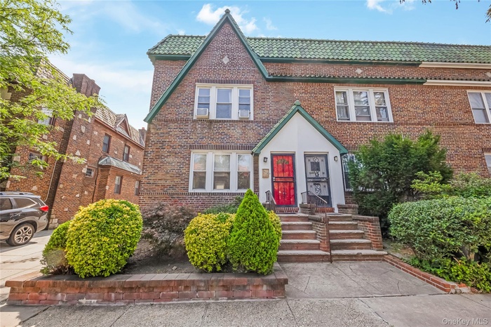 Tudor-style house with a tile roof and brick siding