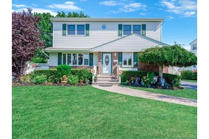 Welcome to this meticulously maintained Colonial nestled in the heart of Hicksville, blending classic charm with space and comfort.