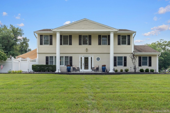 View of front of property featuring covered porch and a shingled roof