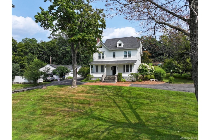 View of front of house featuring a circle driveway and rocking chair front porch