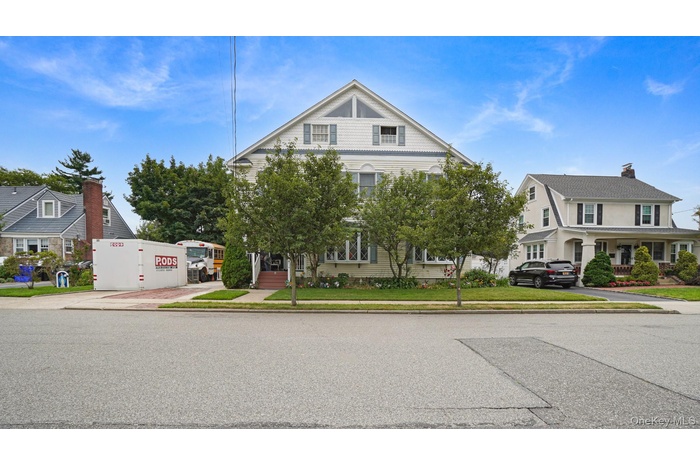 View of front of house with a front yard and a porch
