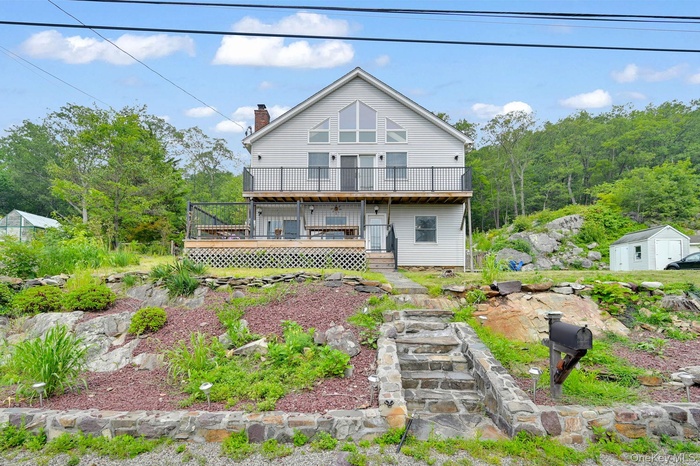 Tucked into the hillside with panoramic windows and wraparound decks—47 Blueberry Hill is your private retreat.