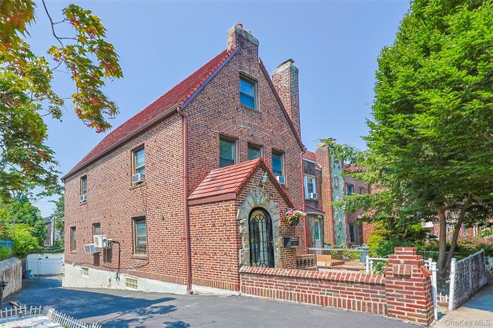 View of side of property with brick siding and a chimney