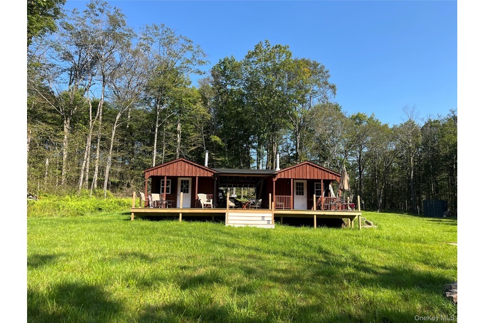 Rear view of house featuring a yard