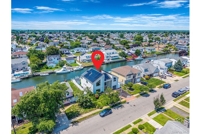 Aerial view of residential area featuring a nearby body of water