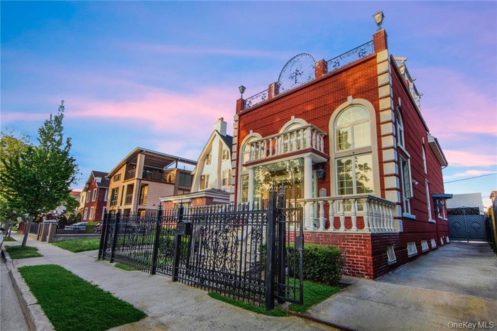 Property at dusk featuring a fenced front yard