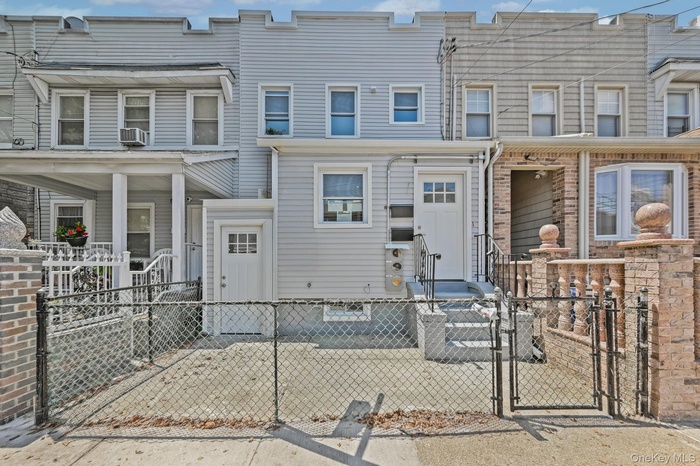 Traditional-style house with a gate and a fenced front yard