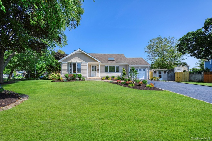Ranch-style house with driveway and a garage