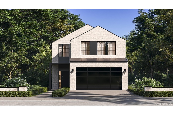 View of front of home with driveway, a standing seam roof, an attached garage, and brick siding