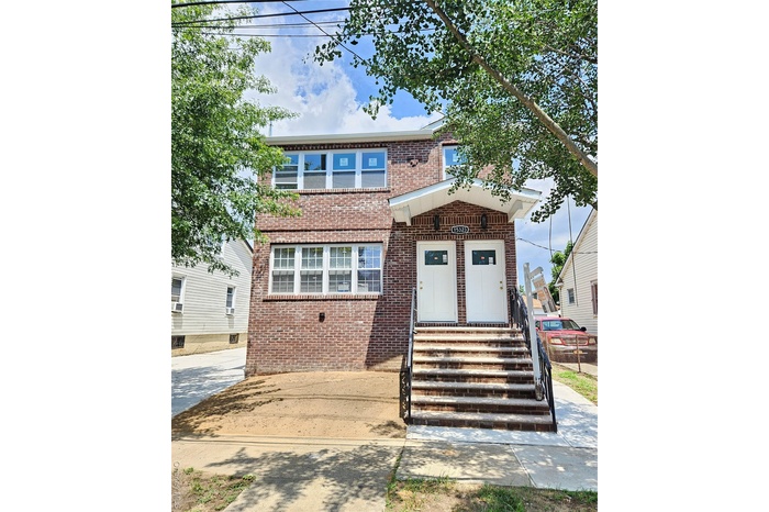 View of front of house with brick siding