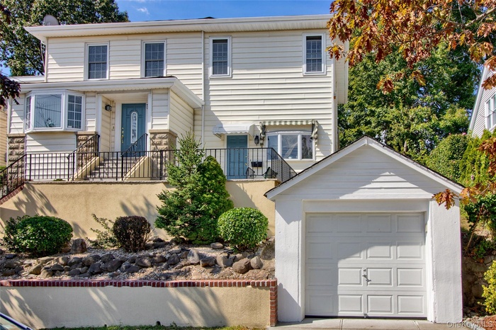 Traditional-style home featuring an outbuilding and a detached garage