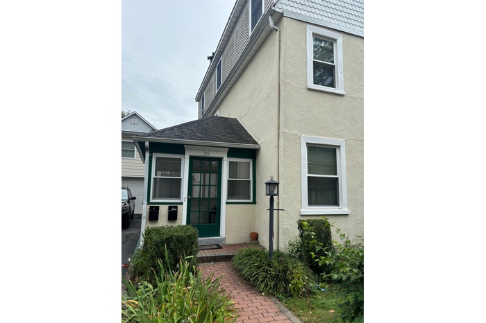 View of exterior entry with stucco siding