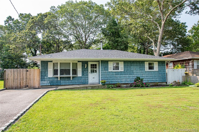 View of front of property with roof with shingles