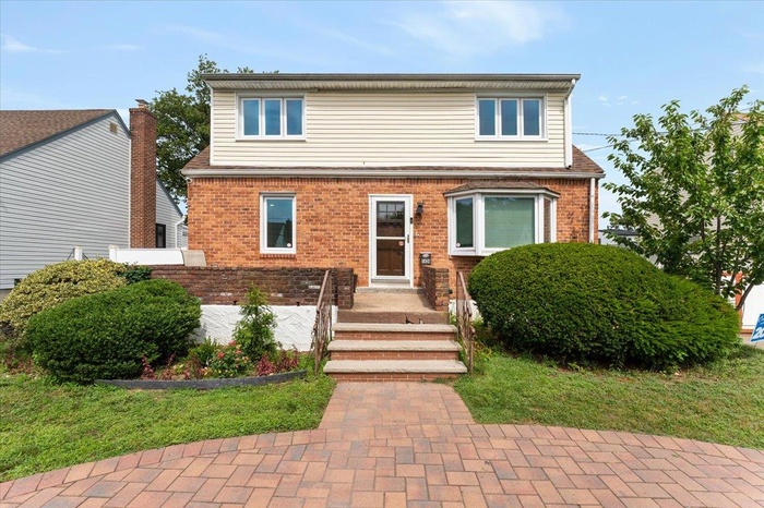 Traditional-style home featuring brick siding