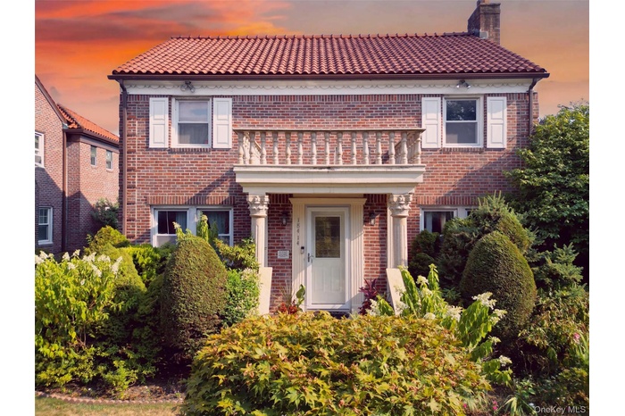 Mediterranean / spanish house with brick siding, a chimney, and a tile roof