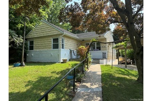An open floor plan, set back on a hill, with a full finished basement with a bath and laundry room, quiet deck off the family room has great potential !