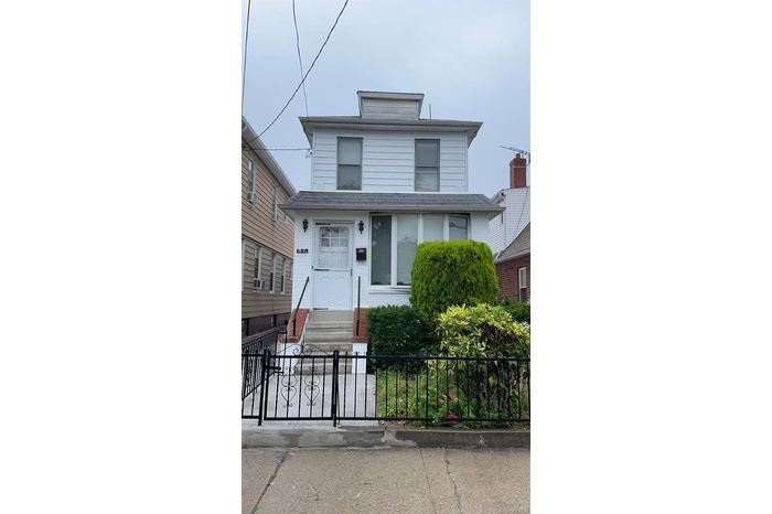 View of front of house with a fenced front yard, a gate, and entry steps