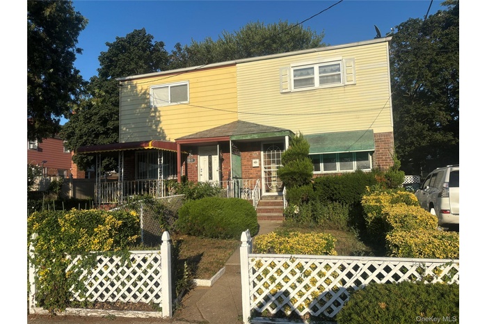 Traditional-style house with brick siding