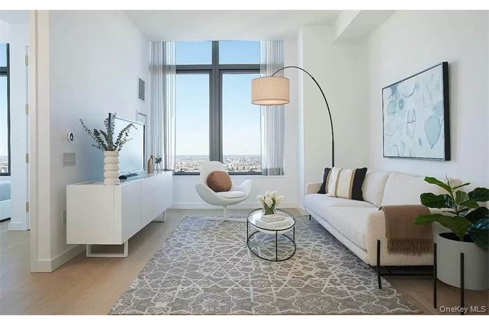 Living area with light wood-type flooring and baseboards