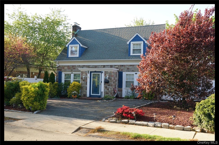 New england style home with stone siding.