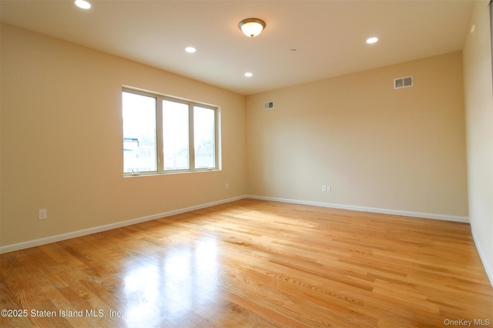 Empty room with recessed lighting and light wood-style floors
