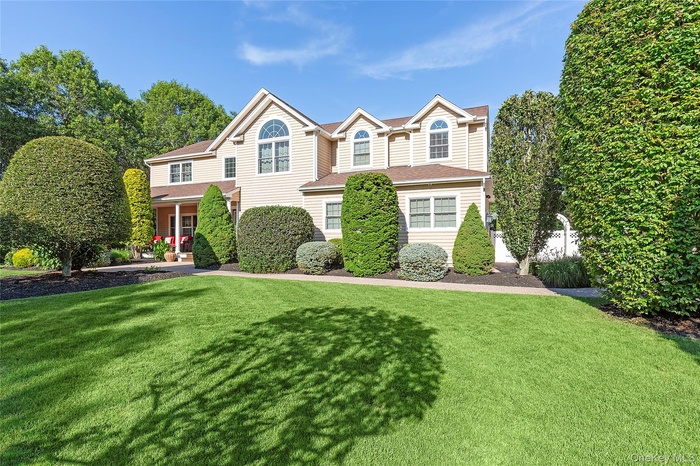 Traditional-style home featuring a front lawn