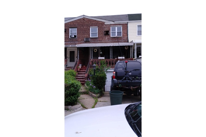 View of property featuring brick siding and stairway