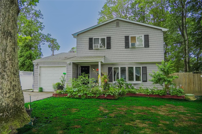 View of front facade with a garage and concrete driveway