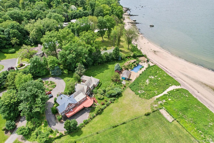 Aerial view of property and surrounding area featuring a large body of water