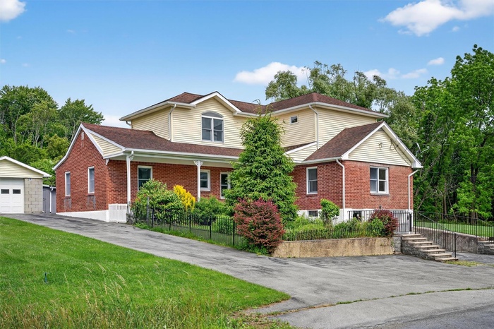Front and side of home. 2150 sq ft. Tons of curb appeal and plenty of private parking.