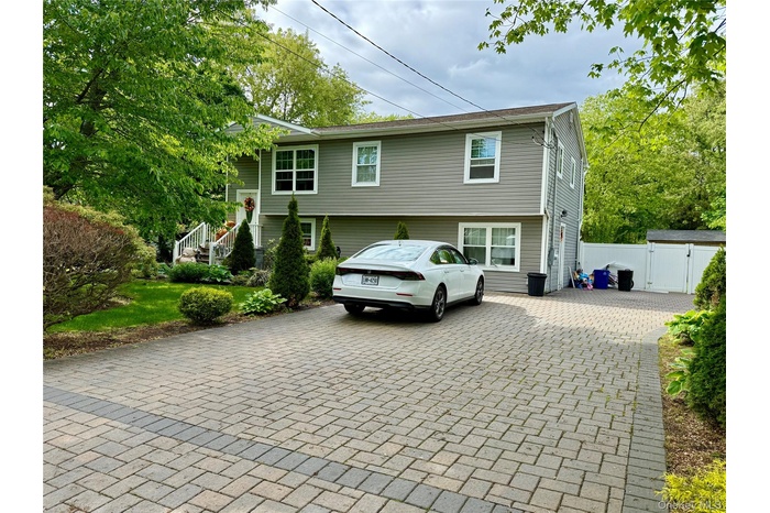 View of front of house featuring a gate and driveway