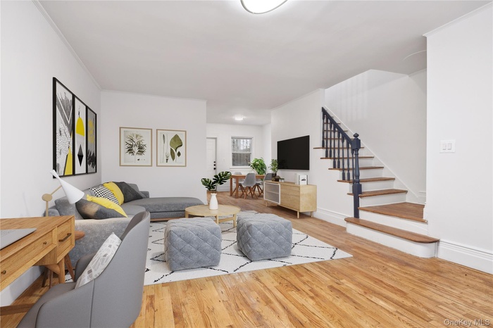 Living room featuring wood finished floors and stairs