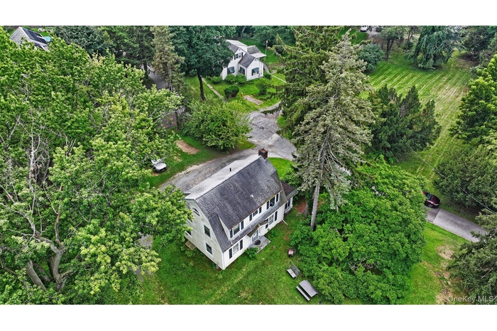 View of property location featuring a tree filled landscape