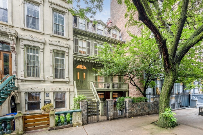 View of property featuring stairway and a fenced front yard