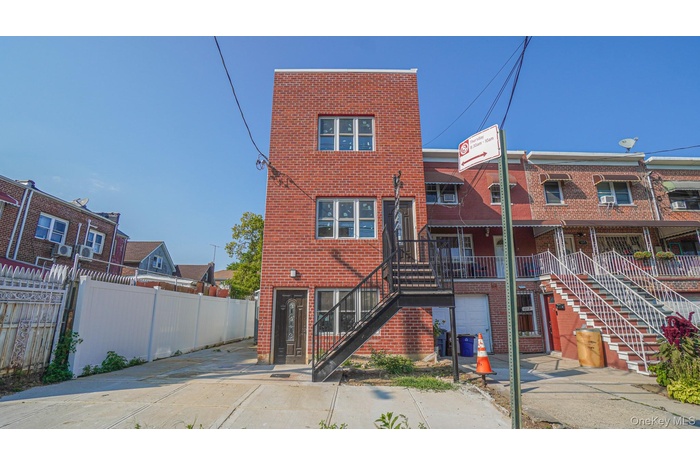 Front of house featuring brick siding and stairway