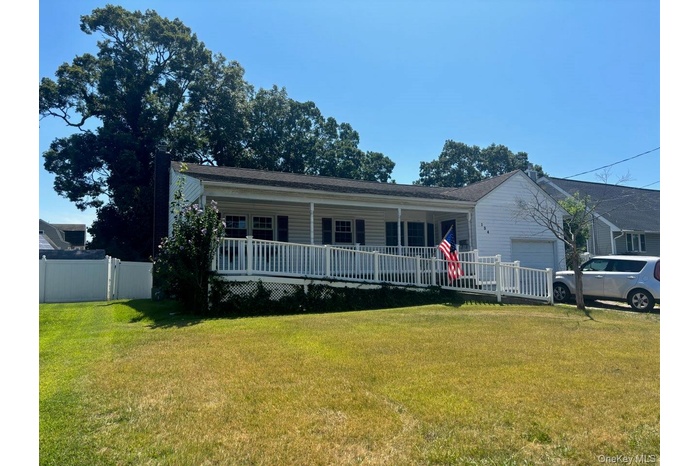 View of front facade featuring covered porch and a garage