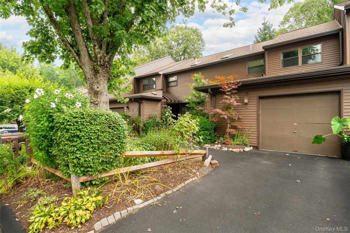 View of front of home with driveway and attached garage
